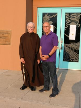 Brother Edwin meets a parishioner outside of St. Genevieve's Church.